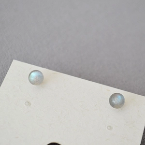 Detailed close-up of spherical labradorite stud earrings with blue flash on display