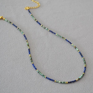 Detail of beaded turquoise and lapis lazuli necklace with gold metal spacers