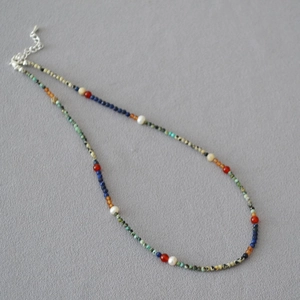 Detail of beaded necklace with lapis lazuli, turquoise, and freshwater pearls