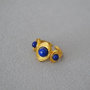 Detail of vintage gold-plated ring featuring handmade wire wrap and blue lapis stones