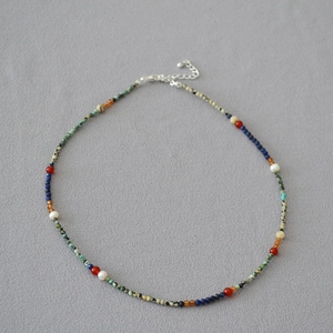 Detail of beaded necklace featuring turquoise, lapis lazuli and freshwater pearls