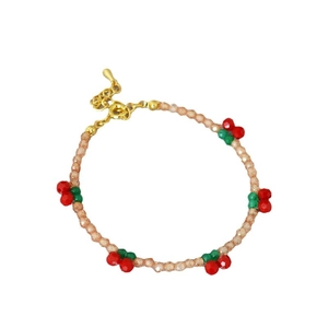 Handmade beaded bracelet with champagne crystals and red cherry charms and gold clasp