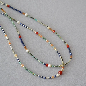 Detail of bohemian necklace with lapis lazuli, turquoise, and freshwater pearls