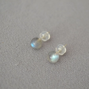 Macro shot of natural labradorite ball earrings with 925 silver pins and silicone backs