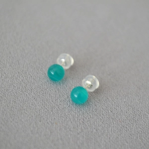 Macro shot of teal round bead stud earrings with 925 silver pins and silicone backs