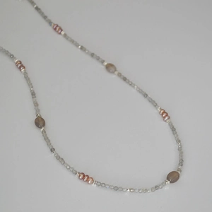 Detailed macro view of minimalist beaded necklace with grey labradorite and pink pearls