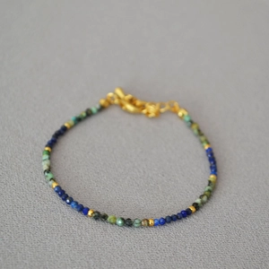 Close-up of handmade beaded necklace with turquoise lapis lazuli and gold lobster clasp
