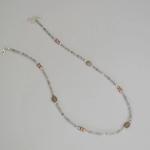 Close-up of beaded necklace featuring labradorite stones and freshwater pearls with clasp