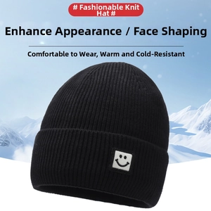 Detailed view of black knitted beanie with smiley face patch and warm fold-over cuff