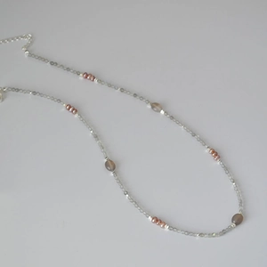 Detailed view of faceted labradorite beads and pink freshwater pearls on a slim necklace