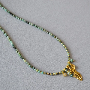 French vintage necklace with turquoise beads and gold hollow leaf charm in artistic style