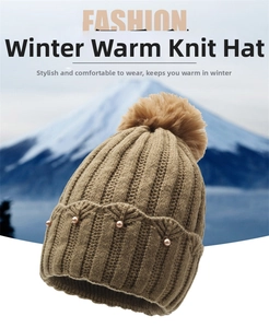Detail of camel knitted winter hat with pearls, pom-pom, and warm thick cable knit texture