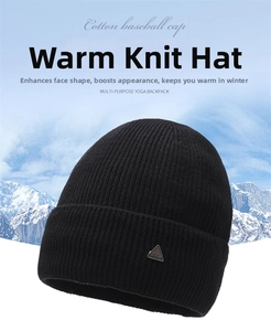 Detail of black ribbed knit beanie featuring a decorative triangle metal patch for winter