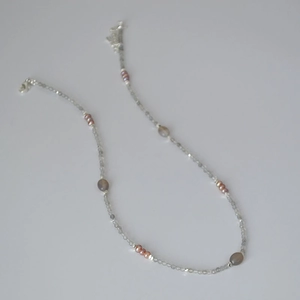 Detail of grey labradorite beads and pink freshwater pearls on a delicate beaded necklace