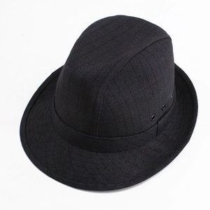 Close-up of black wool fedora hat showing breathable metal eyelets and fabric texture