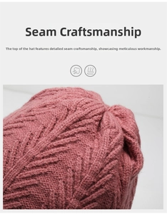 Detailed stitching at the top of a pink knitted winter hat with a textured wool pattern