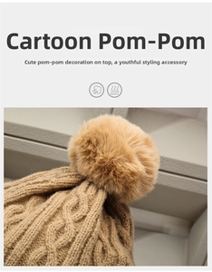Detail of camel cable knit beanie showing thick texture and large faux fur pompom