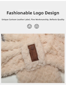 Detail of soft beige faux fur material and a brown leather tag with a cute bear logo