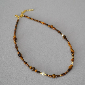 Close-up of tiger eye beaded necklace with adjustable gold chain and lobster clasp