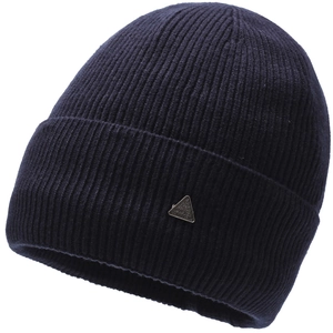 Detail of navy knit beanie showing thick ribbed texture and silver triangle metal badge