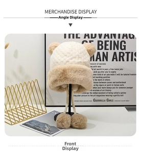 Dettaglio del cappello in maglia beige con fodera in pelliccia sintetica e orecchie d'orso