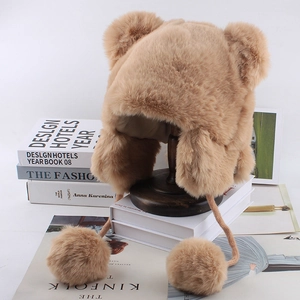 Detail of plush bear ear hat with fluffy pom-poms and warm faux fur texture