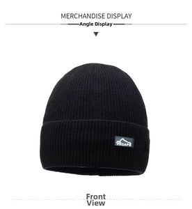 Detail of black knitted beanie with mountain logo patch and soft thermal texture