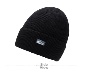 Detail of black ribbed knit beanie featuring a stitched outdoor mountain logo patch