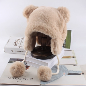 Detailed texture of brown faux fur bear hat with soft pom-poms and cute 3D ears