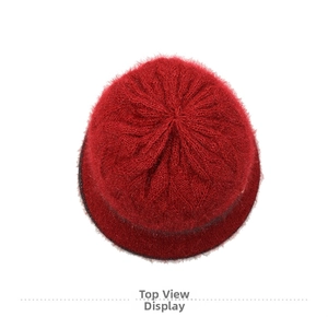 Top down view of red knitted winter hat for women featuring warm cable knit texture