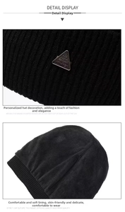 Close-up of black ribbed knit beanie with metal logo and thick warm fleece lining