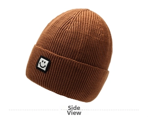 Side view of caramel knitted beanie with detailed square smiley face embroidery patch