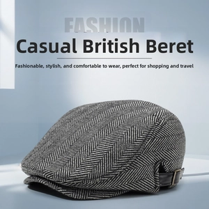 Close-up of retro black and white herringbone wool beret with side leather buckle detail