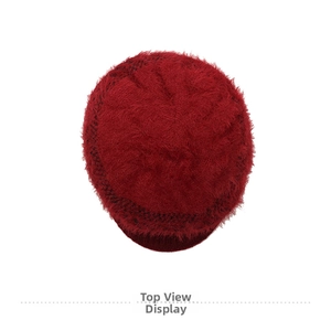 Top view detail of soft red faux fur lining and warm knitted texture on the winter hat