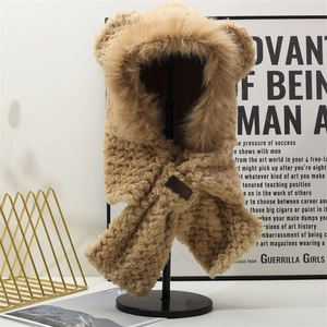 Detail of khaki plush bear ear balaclava with faux fur trim and faux leather patch label