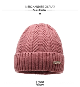 Detail of knit pattern and pearl leaf brooch on winter thermal wool hat for women