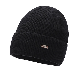 Detail of black ribbed knit beanie featuring the Serflow Kids logo patch and textured weave
