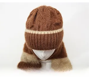 Close-up of thick knitted winter hat scarf set in dark brown with beige stripes