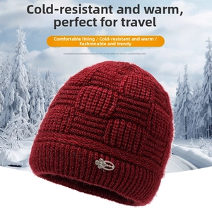 Detailed knit pattern on dark red winter beanie featuring an elegant silver floral buckle