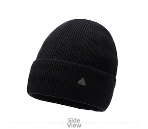Detail of black ribbed knit beanie featuring a silver triangular metal emblem
