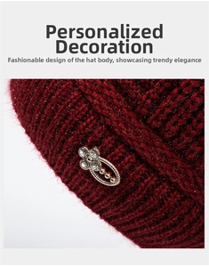 Detailed close-up of dark red knit hat featuring a rhinestone flower metal ornament
