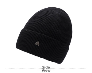 Detail of a black ribbed knit beanie featuring a silver triangular metal ornament on the cuff