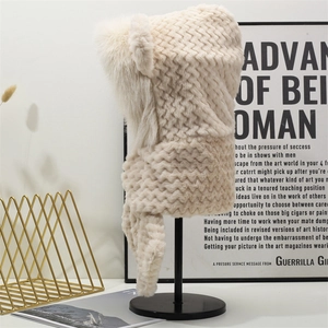 Detail showing wavy texture and plush faux fur trim on a beige thermal hooded scarf hat