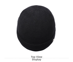 Top down view of black knit beanie showing the premium texture and round crown design