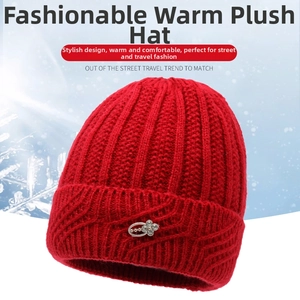 Detail of red knitted winter hat featuring an elegant metal flower accessory for women