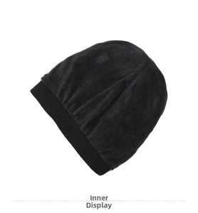 Detail of soft fleece lining inside a black ribbed knit winter beanie hat for warmth