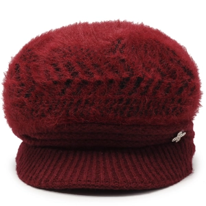 Detail of wine red knit cap featuring plush faux fur texture and silver butterfly ornament