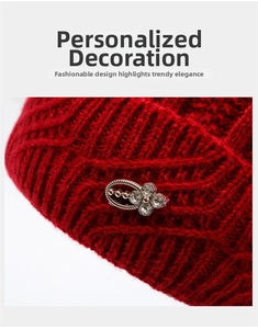 Detail of red knitted winter hat for elderly women showing thick texture and floral ornament