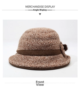 Close-up of brown textured wool blend bucket hat with ribbon and plush ball detail