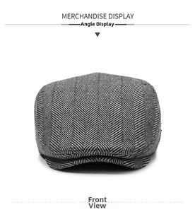 Detailed view of grey herringbone wool fabric texture on a vintage flat cap